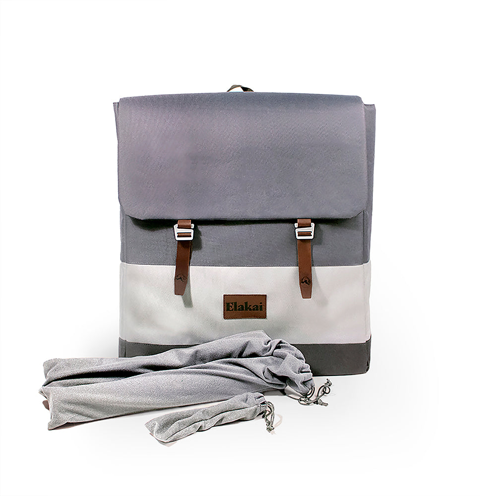 Gray and white backpack with brown straps on a white background