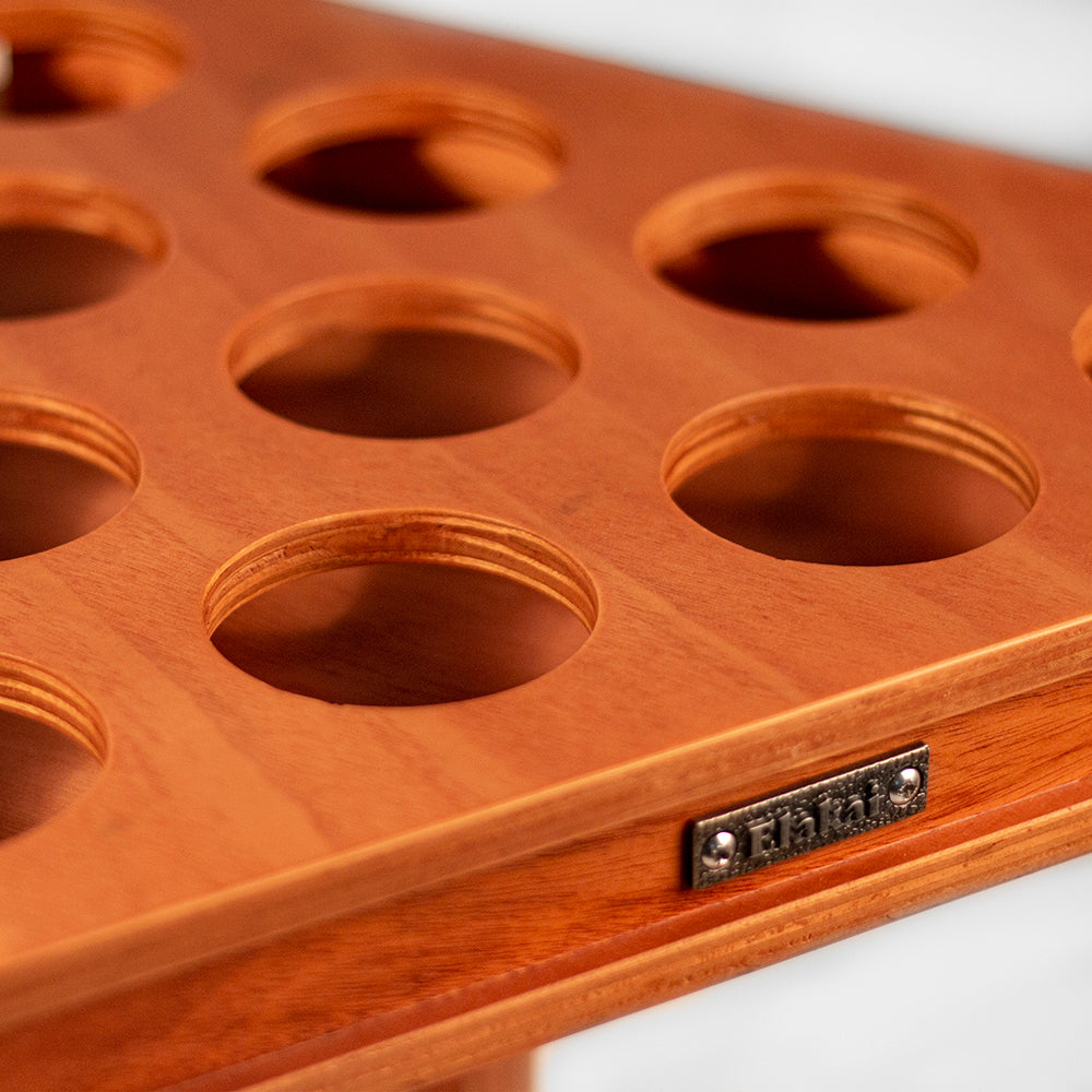Wooden jewelry display tray with multiple compartments and a visible brand logo.