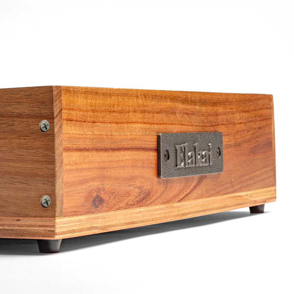 Wooden box with a metal label on a white background