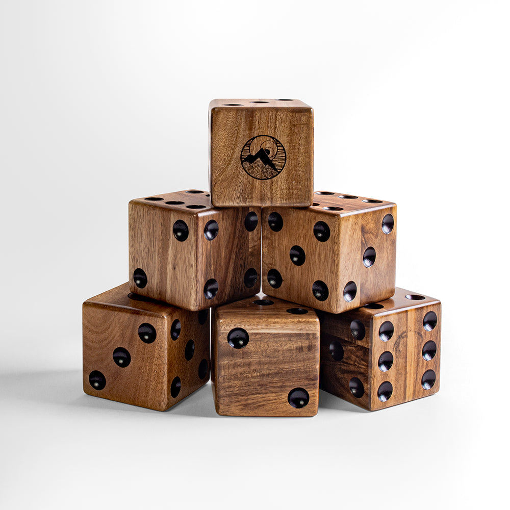 Stack of wooden dice with black dots on a white background