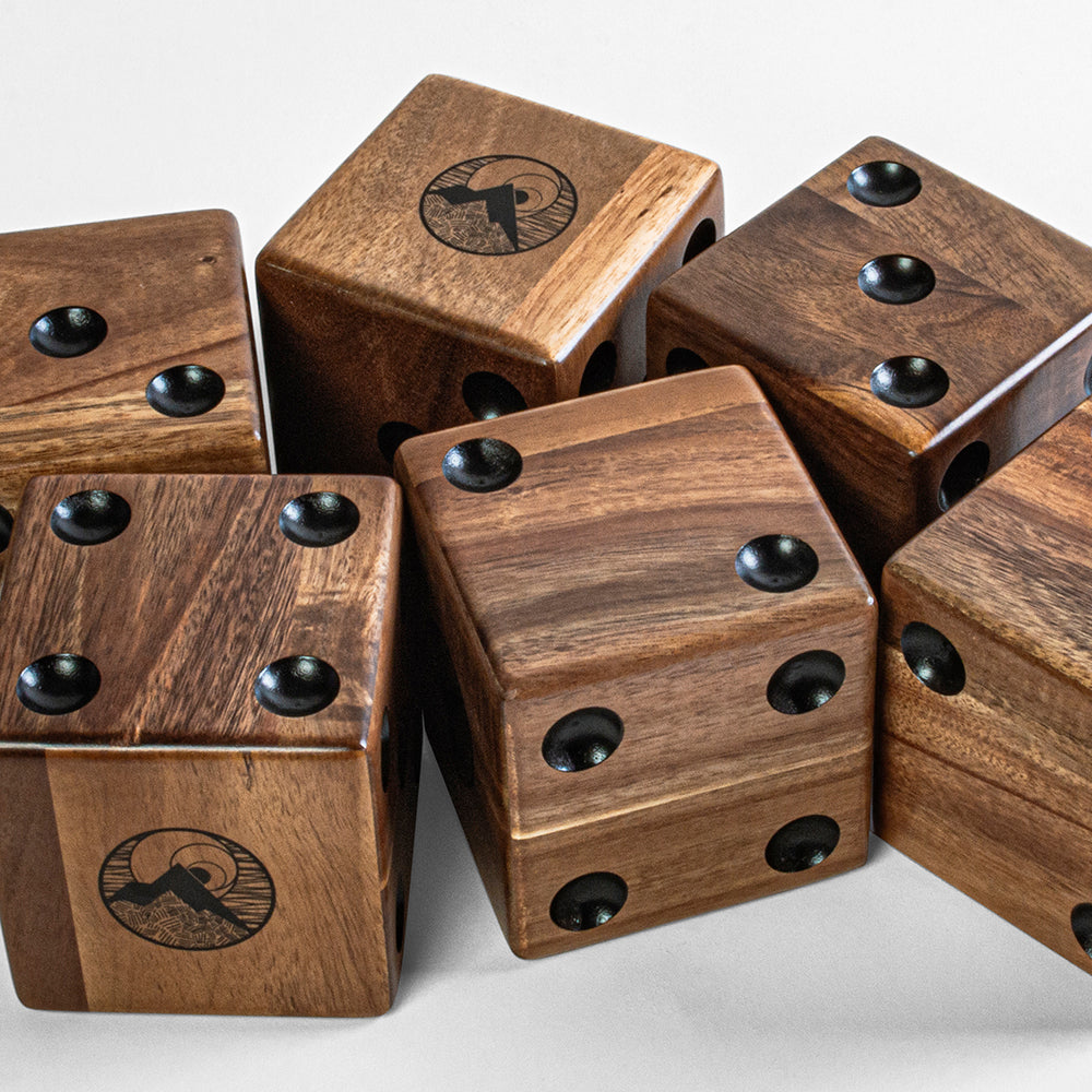 Wooden dice with black dots on a light gray background
