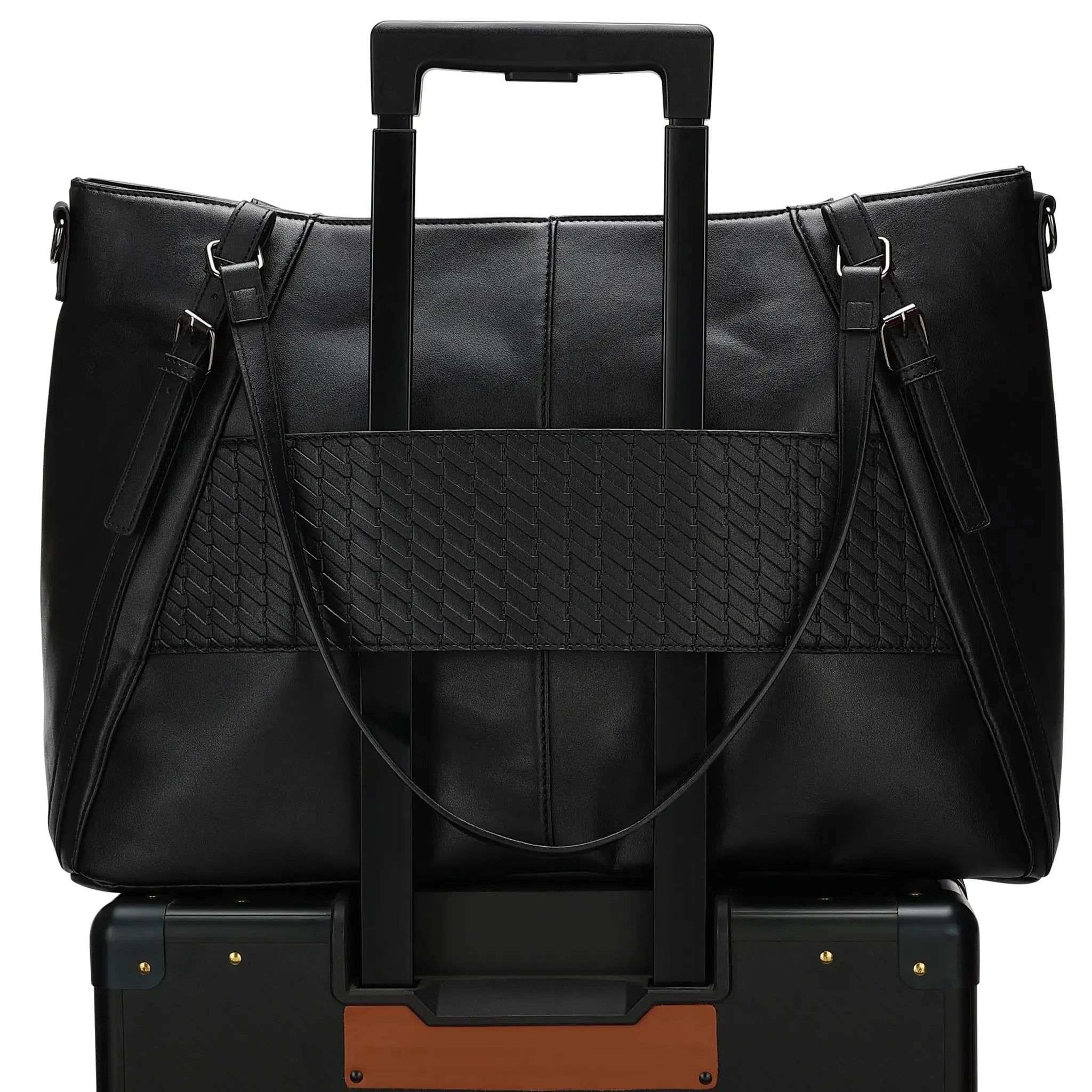 Black leather briefcase on top of a black suitcase with gold accents