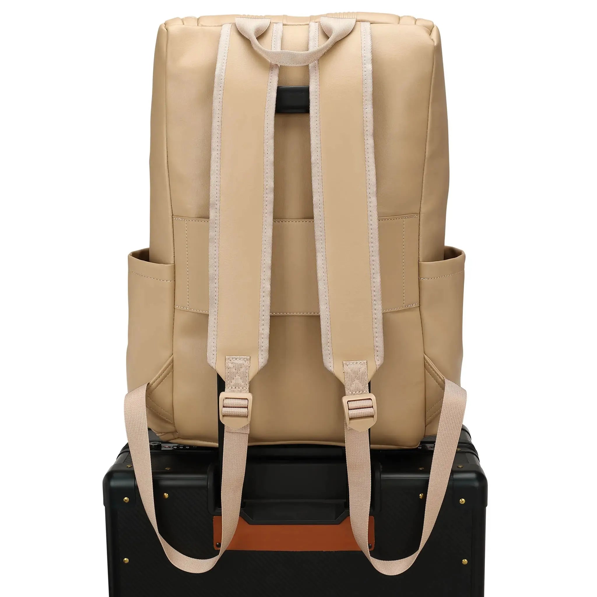 Beige backpack on a black suitcase with a white background