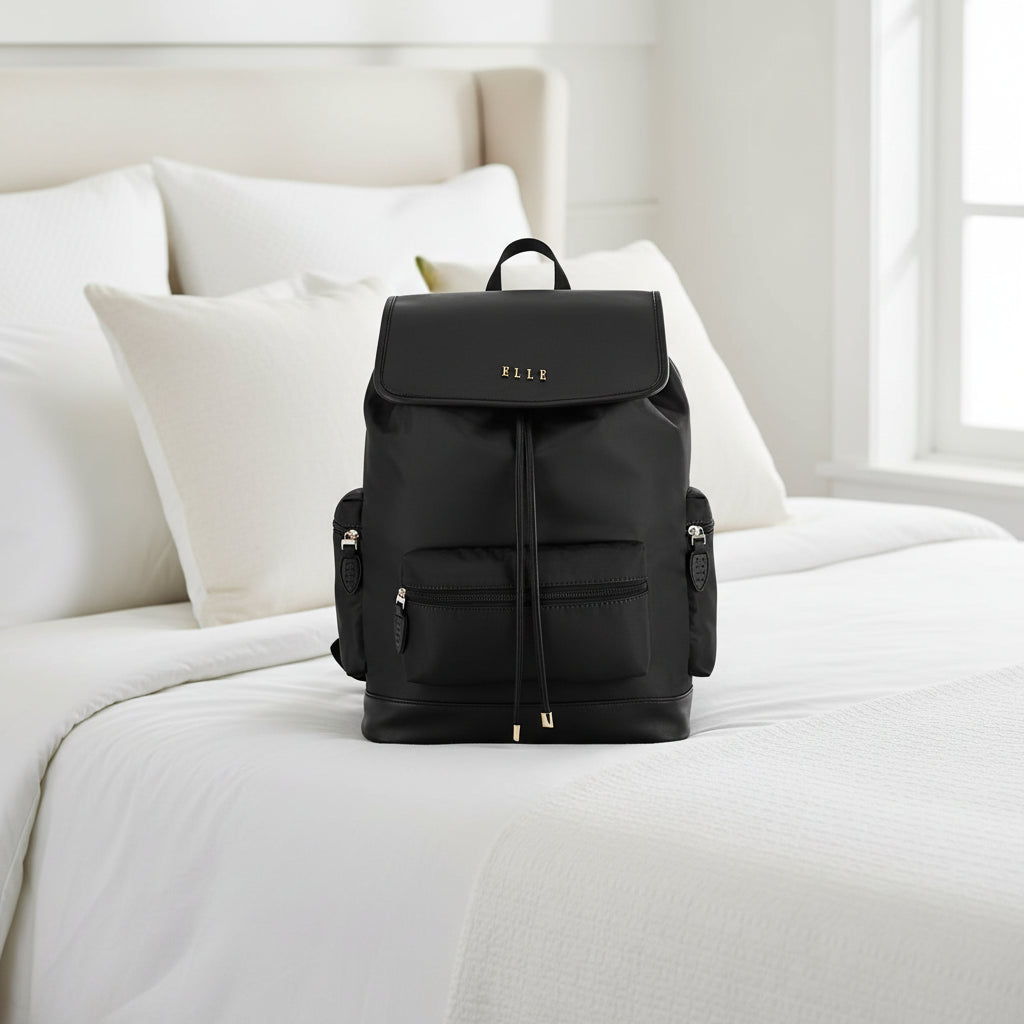 Black backpack with gold accents on a white background