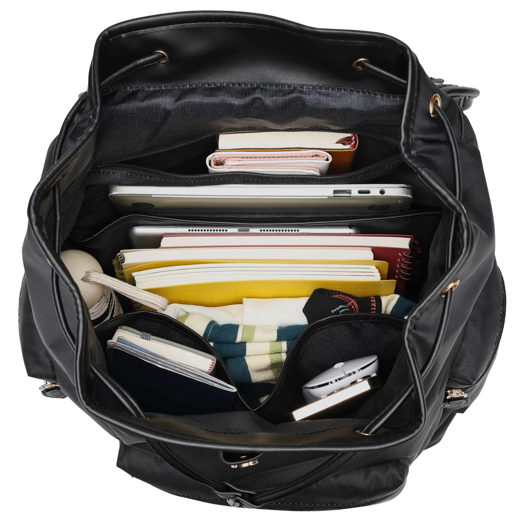Black backpack with various items including books and a laptop on a white background