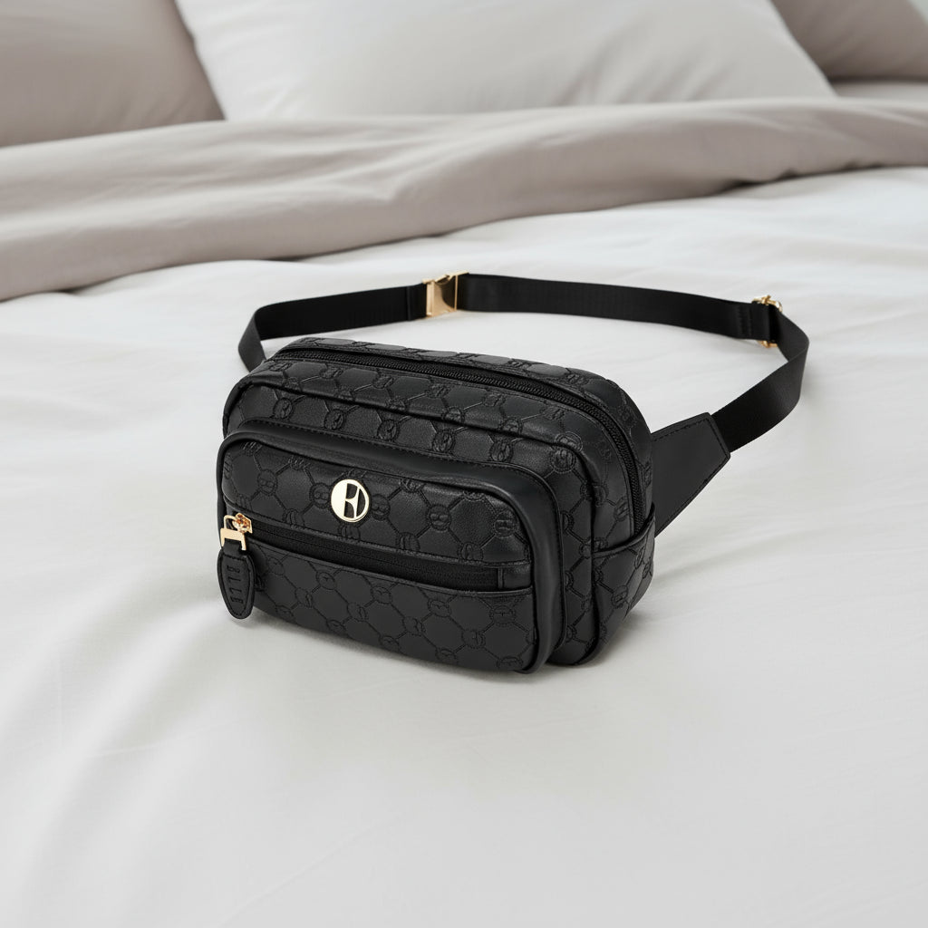 Black quilted fanny pack with gold accents on a white background