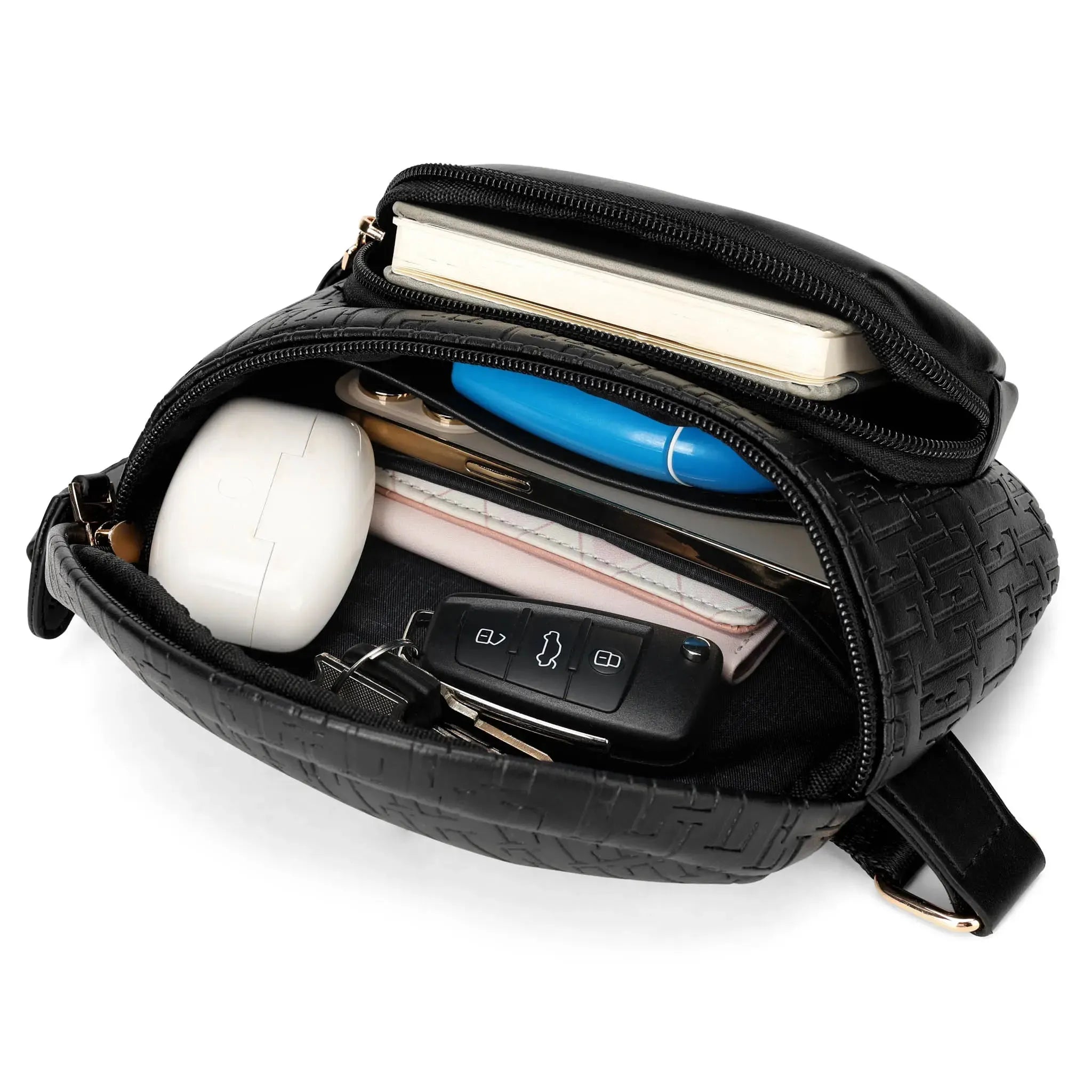 Black crossbody bag with various items including a phone, keys, and a white object.