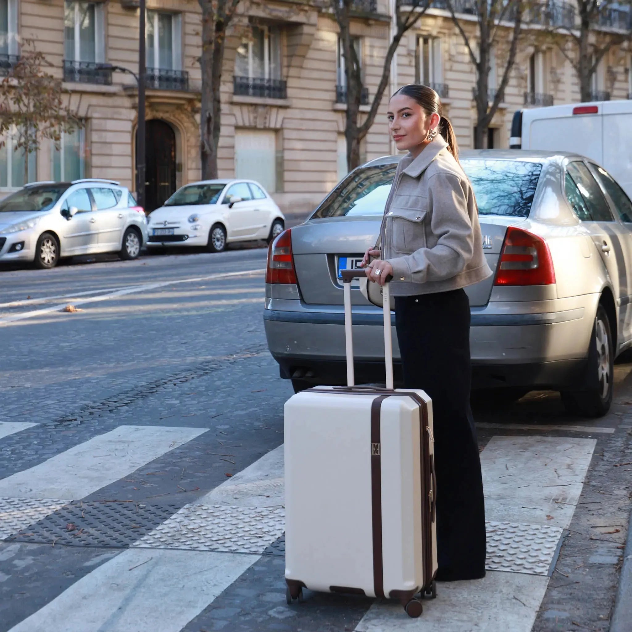Woman with a suitcase on a city street