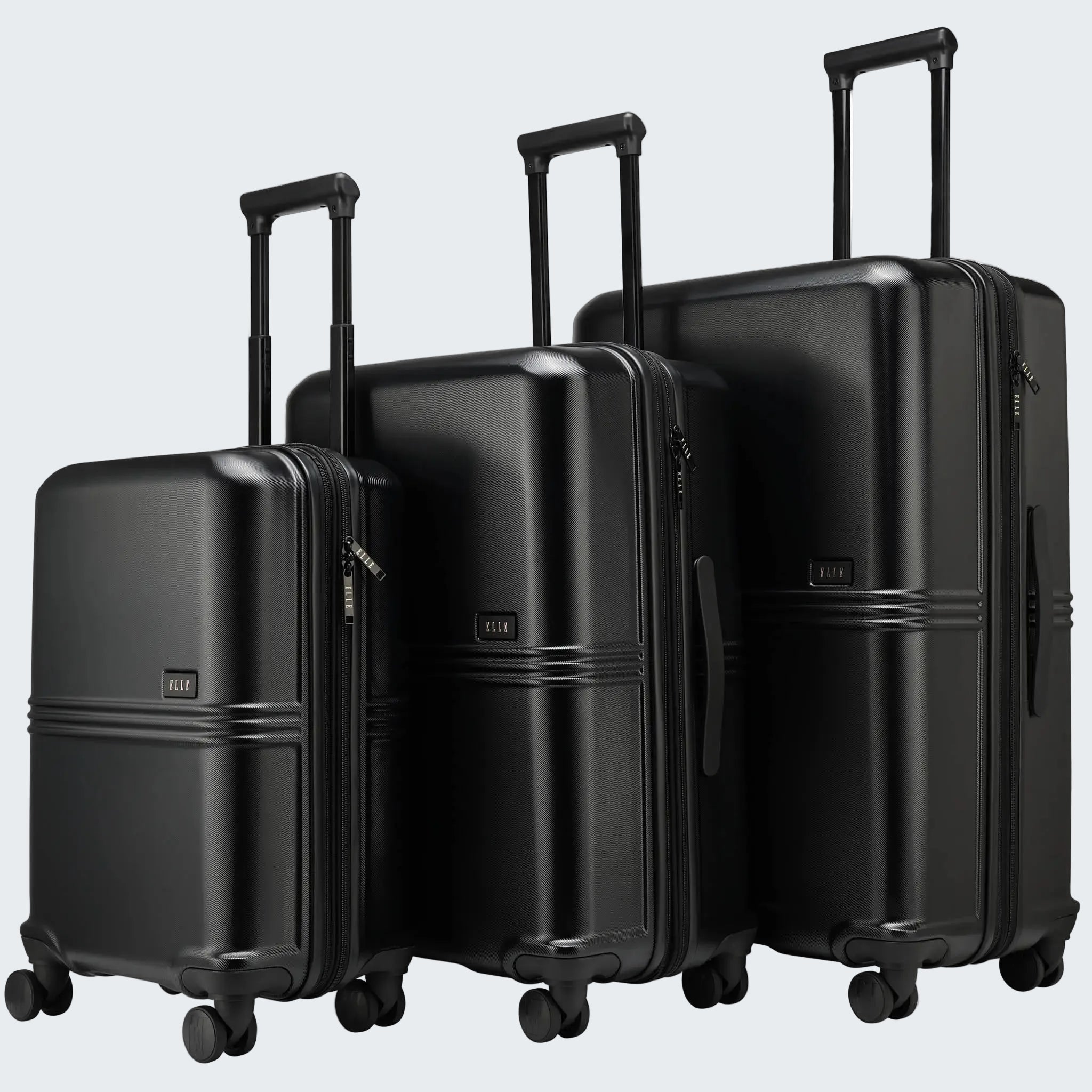 Set of three black suitcases of different sizes on a white background