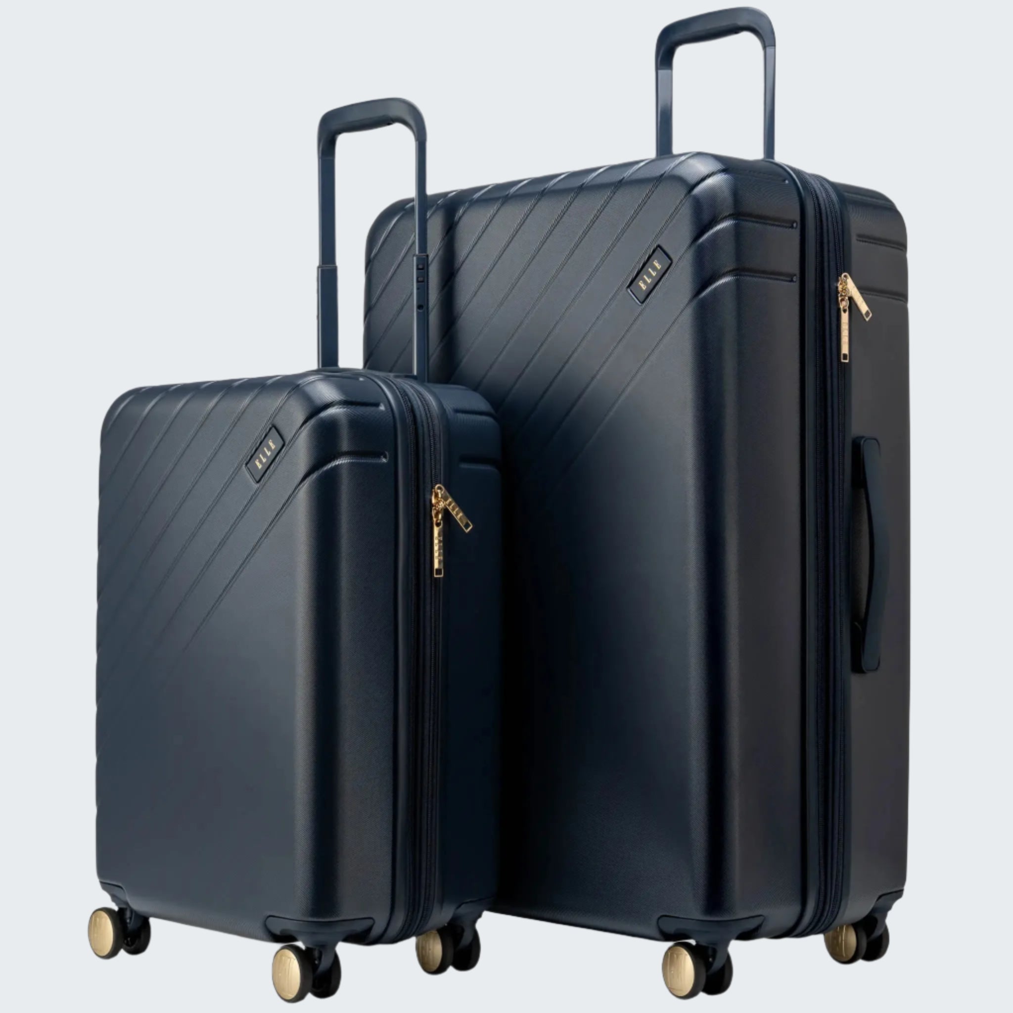 Two navy blue suitcases with gold zippers on a white background