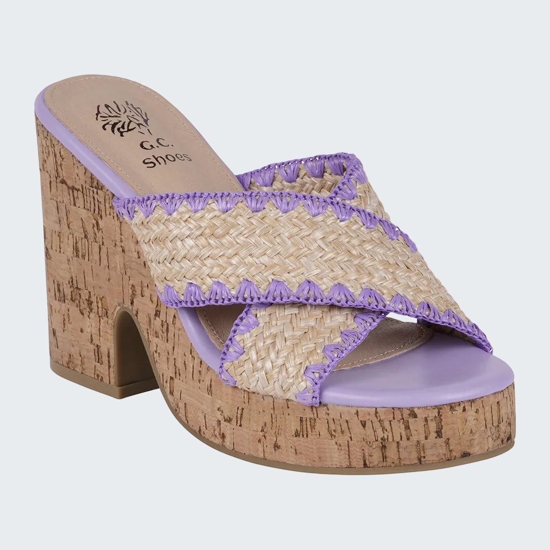 Woven sandal with purple accents and cork sole on a white background