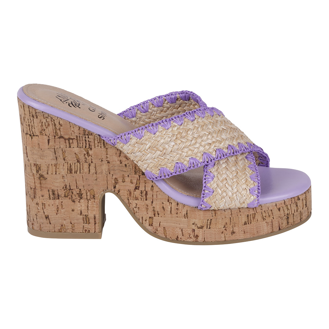 Woven sandal with cork wedge sole on a white background