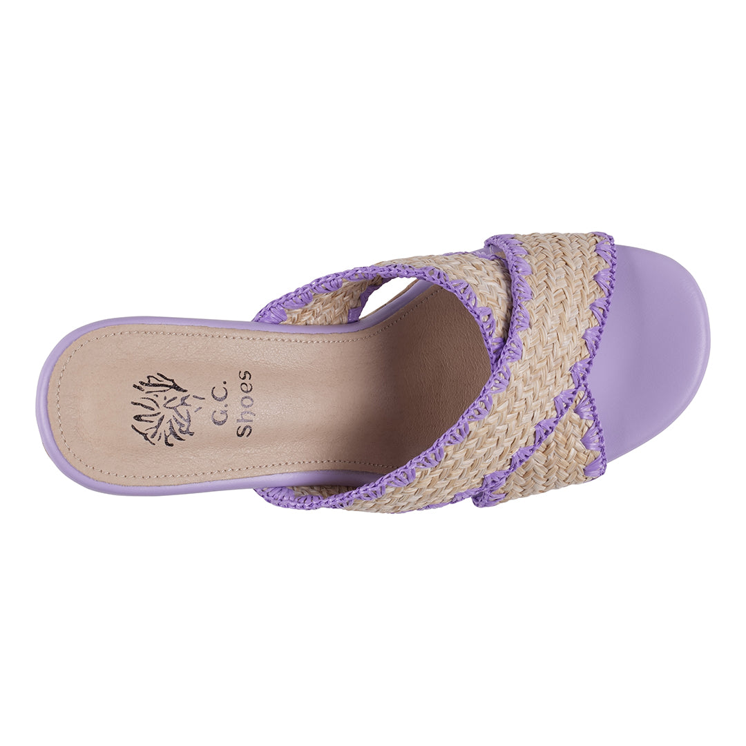 Purple sandal with woven strap on a white background