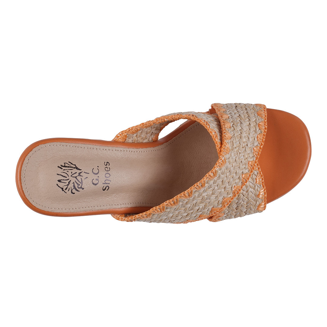 Orange sandal with woven strap on a white background