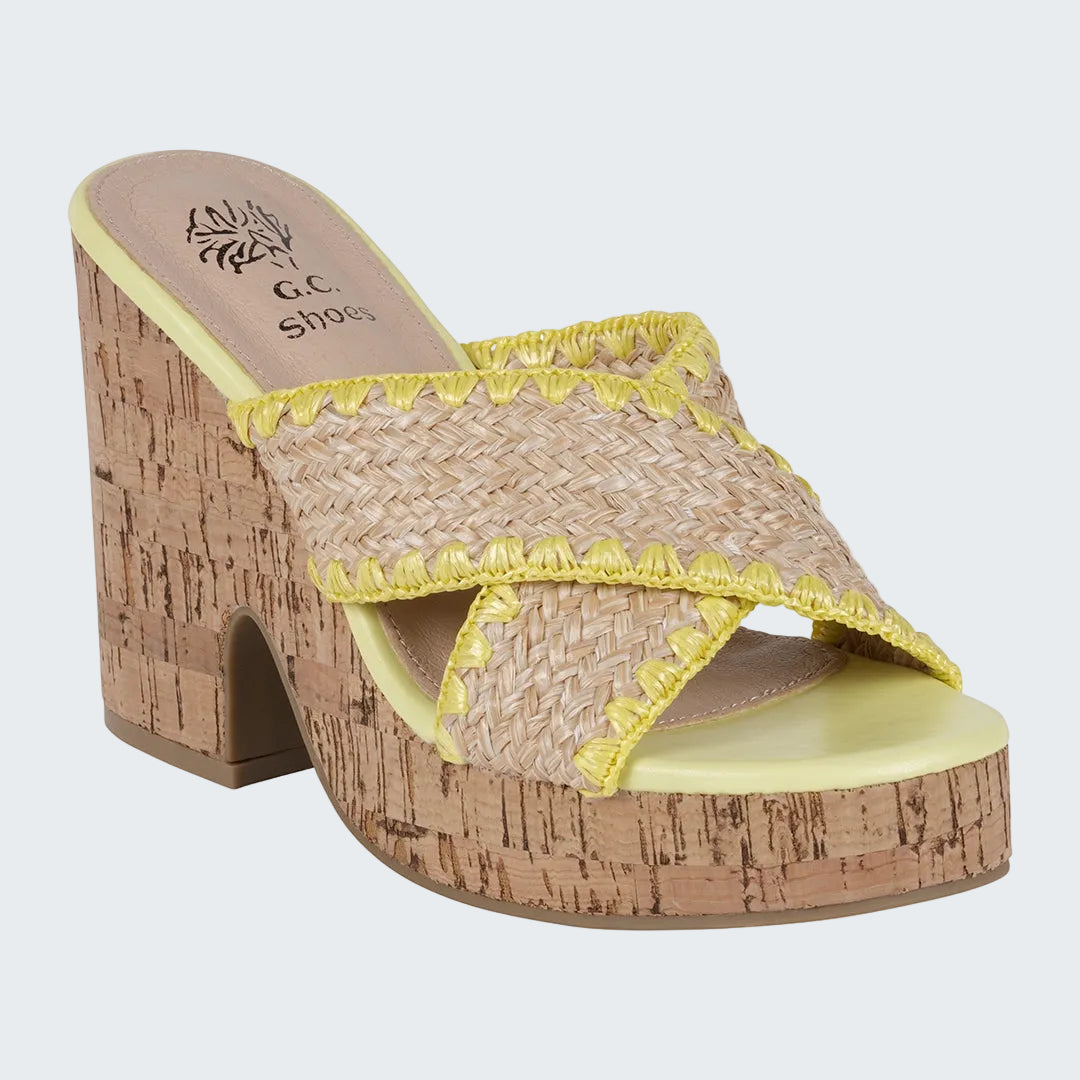 Woven sandal with cork heel and yellow trim on a white background