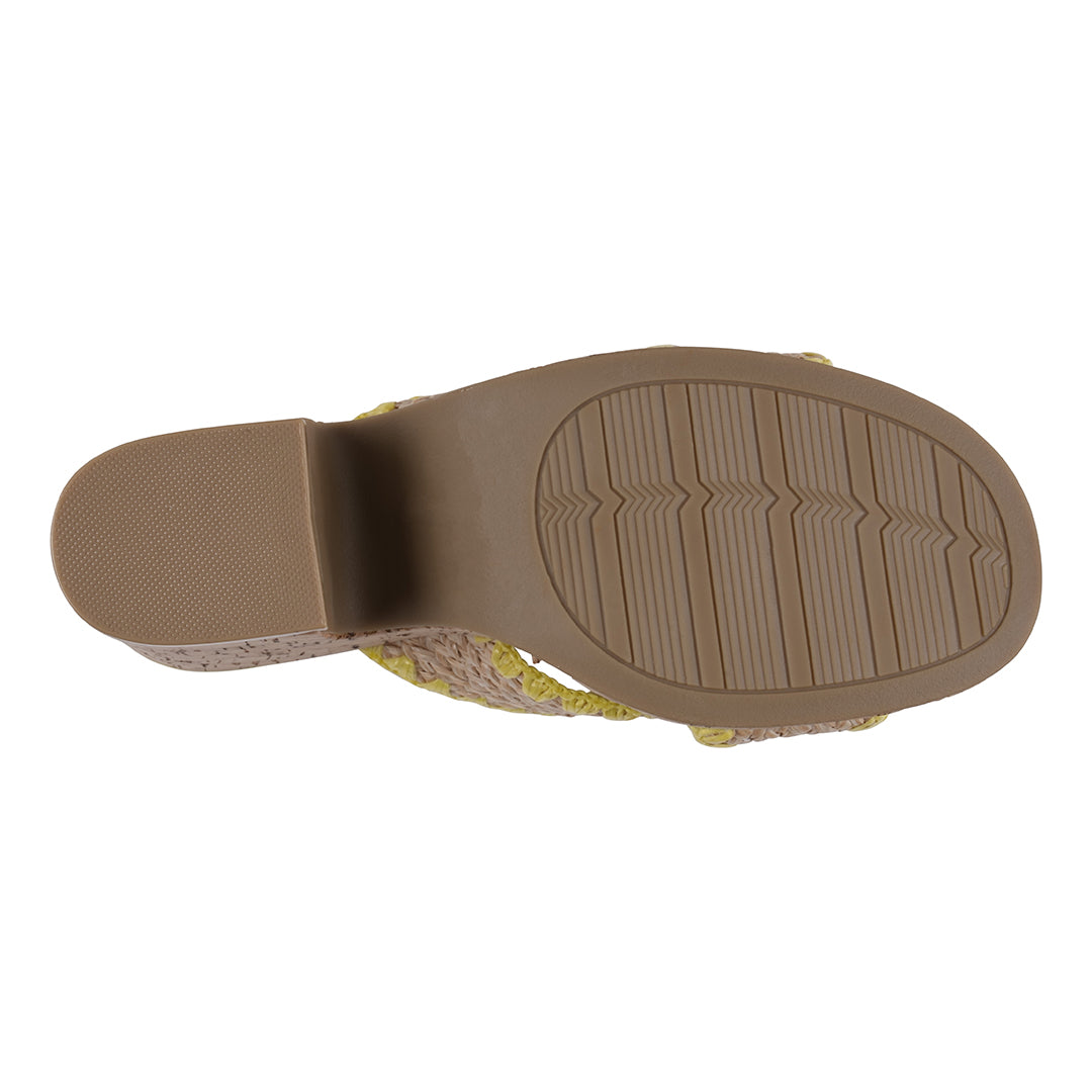 Close-up of a sandal sole with textured brown rubber on a white background