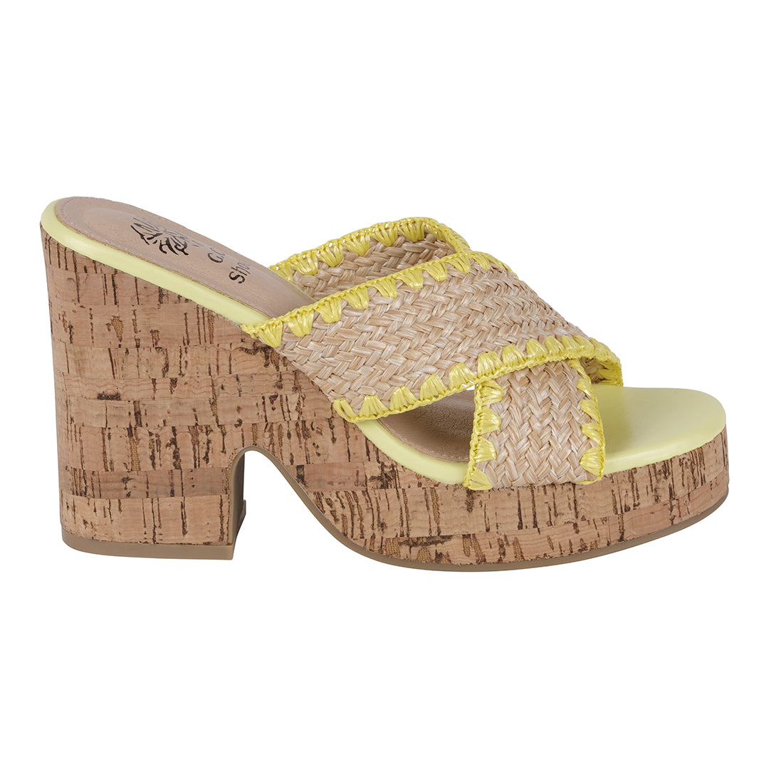 Woven sandal with cork platform and yellow trim on a white background