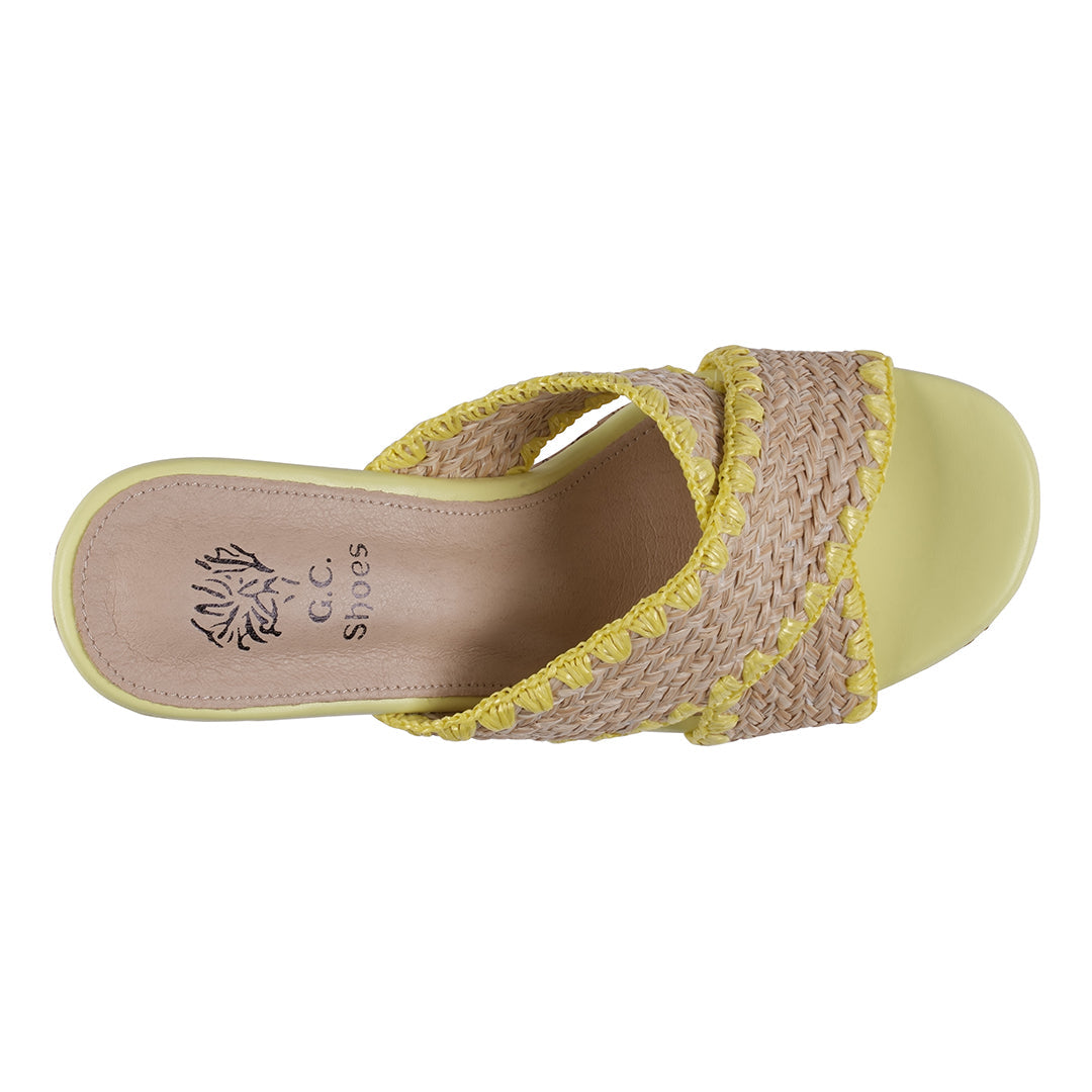Yellow sandal with woven strap on a white background