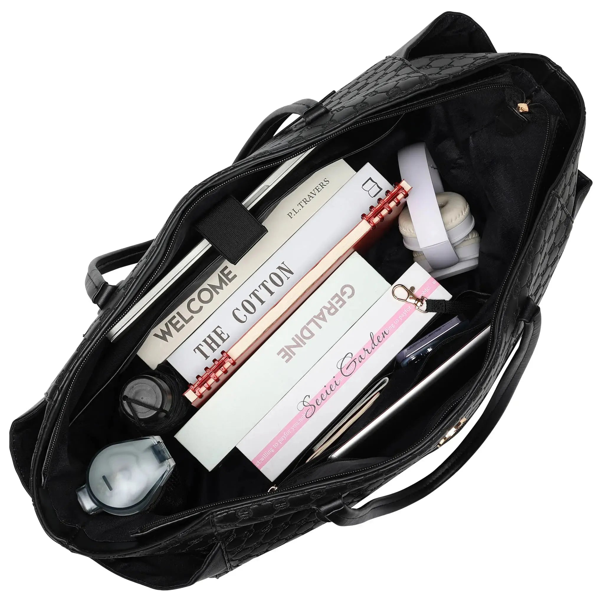 Black bag with stationery items including books and a pen on a white background