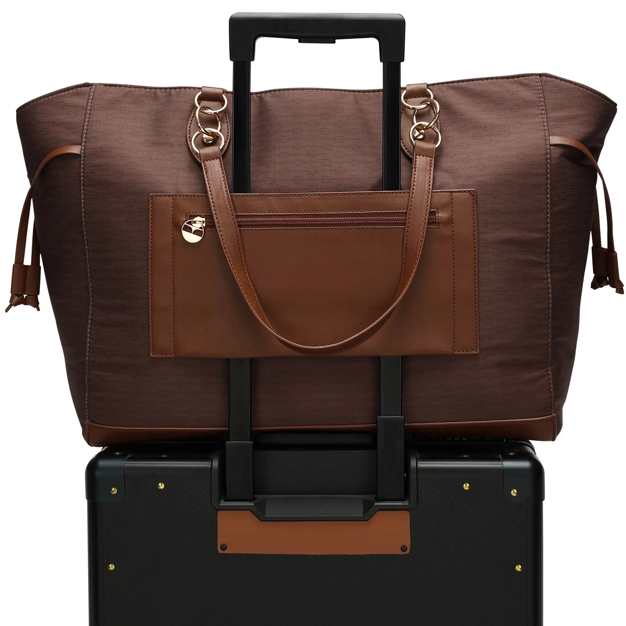 Brown leather bag with gold accents on top of a black suitcase