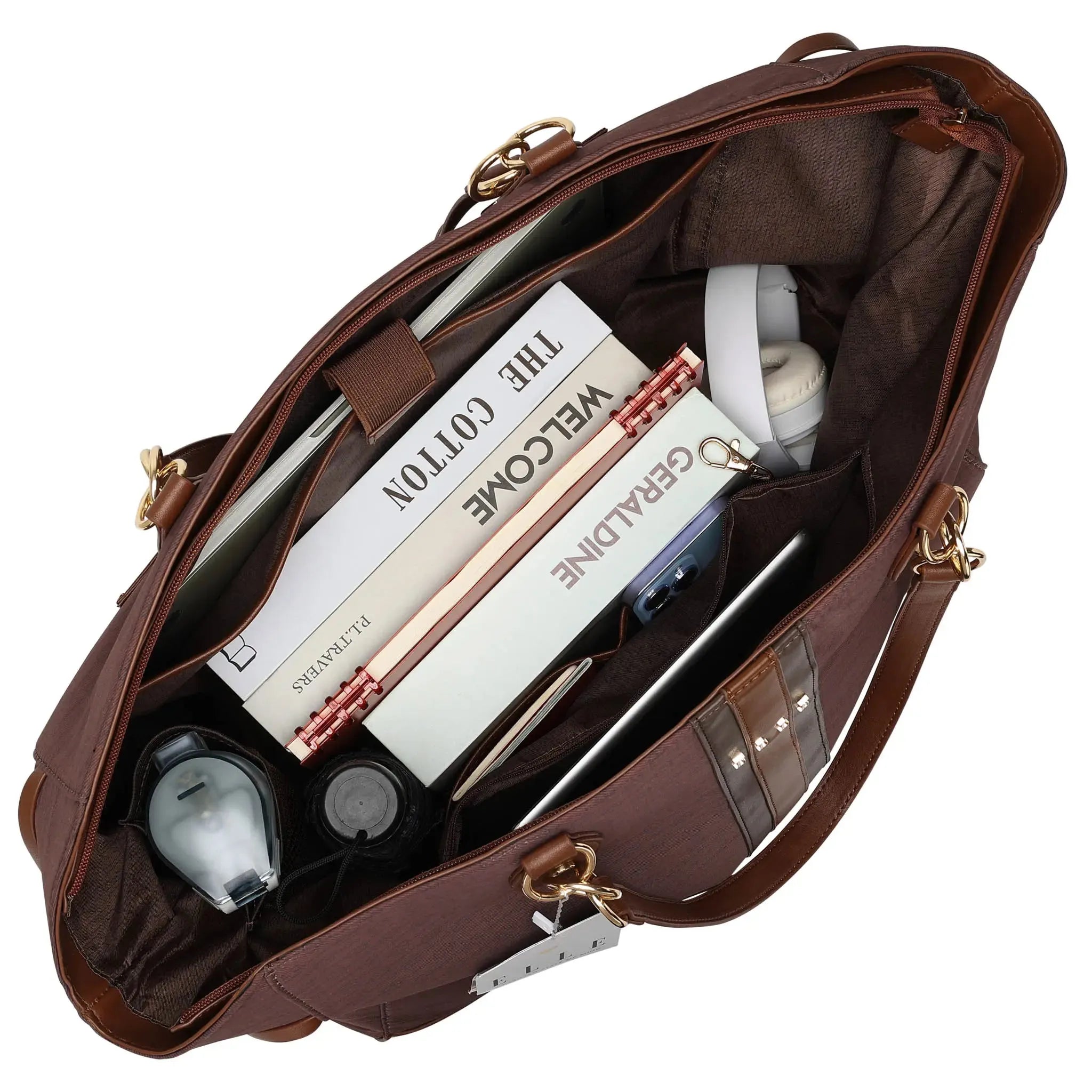 Brown leather bag with items including books and a phone inside