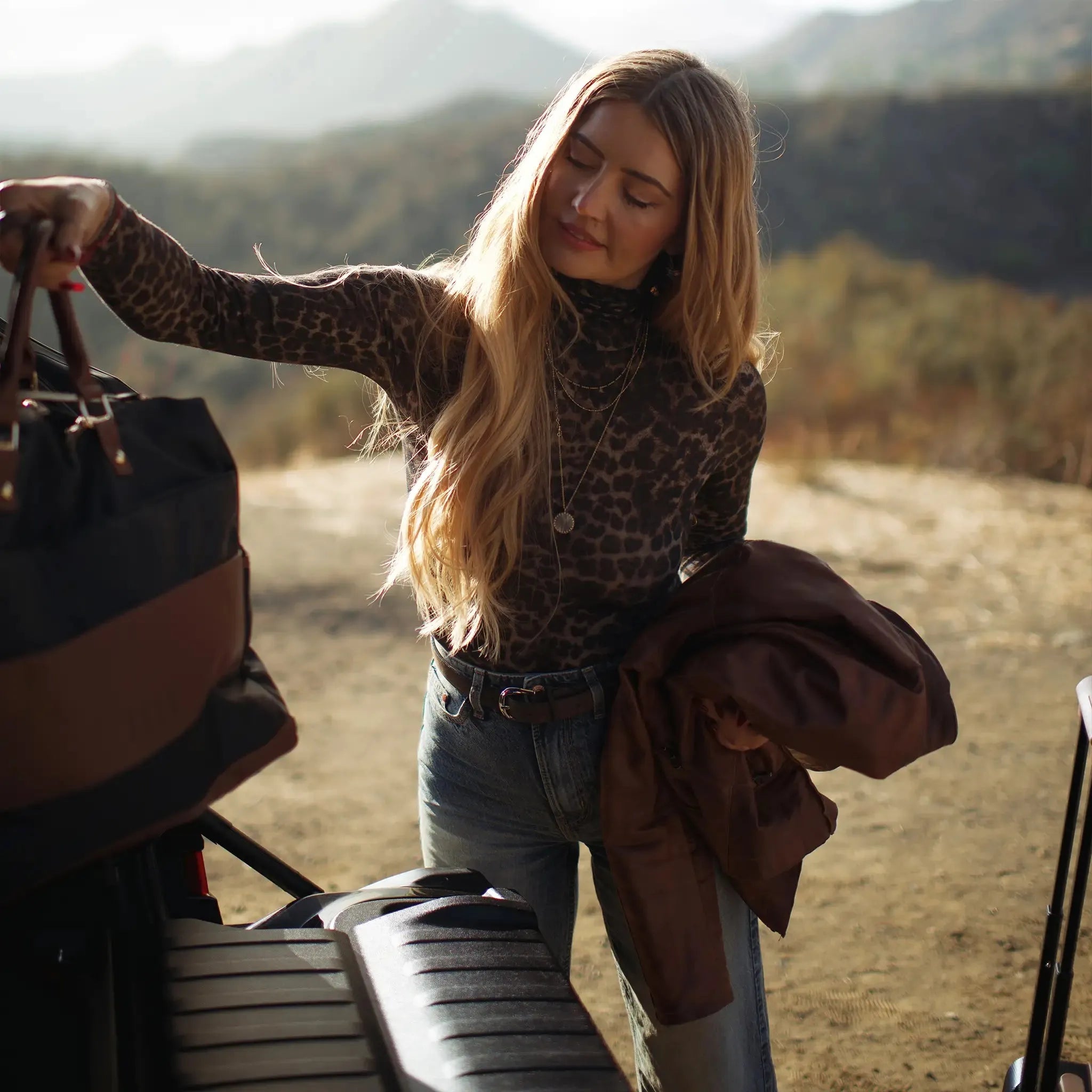 Woman standing next to a vehicle in a natural setting