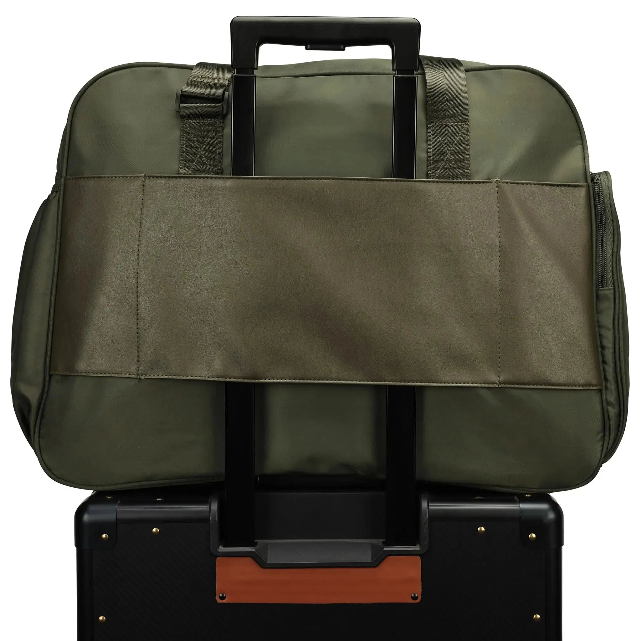 Green travel bag on top of a black suitcase with brown accents