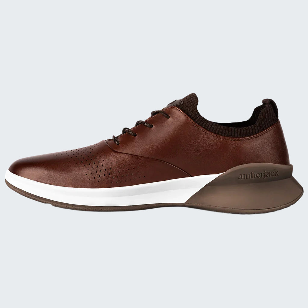 Brown leather shoe with white sole on a white background