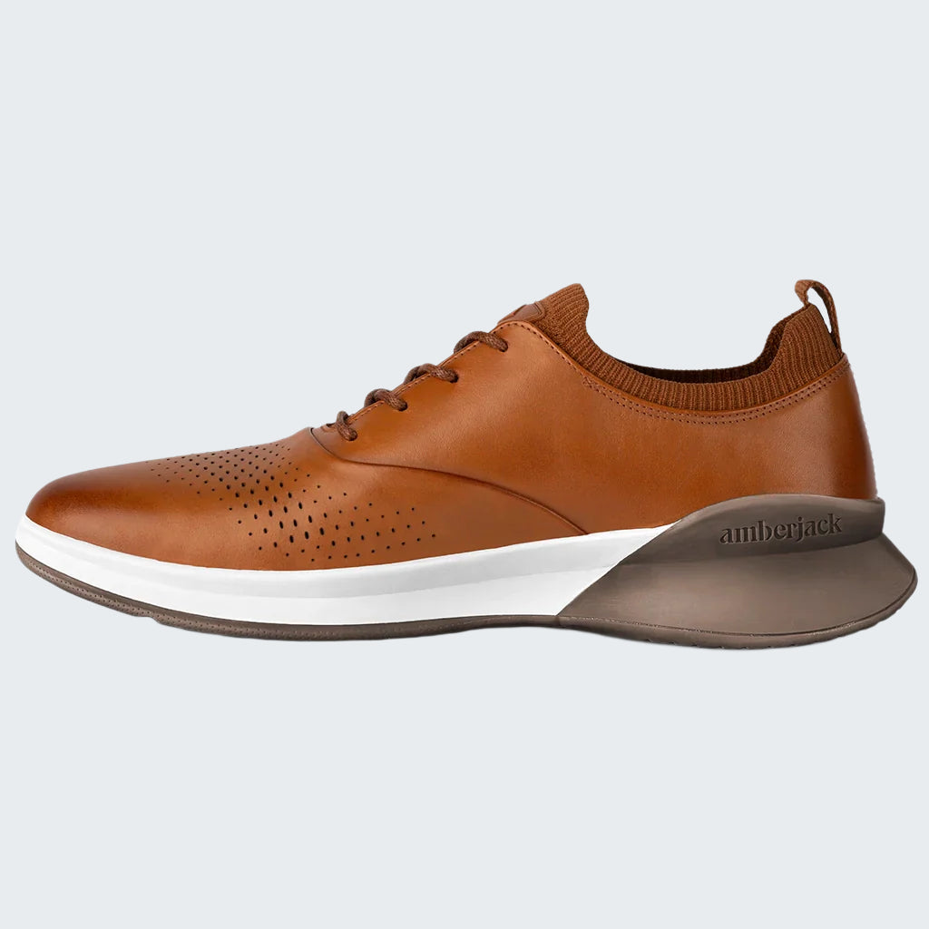 Brown leather shoe with white sole on a white background