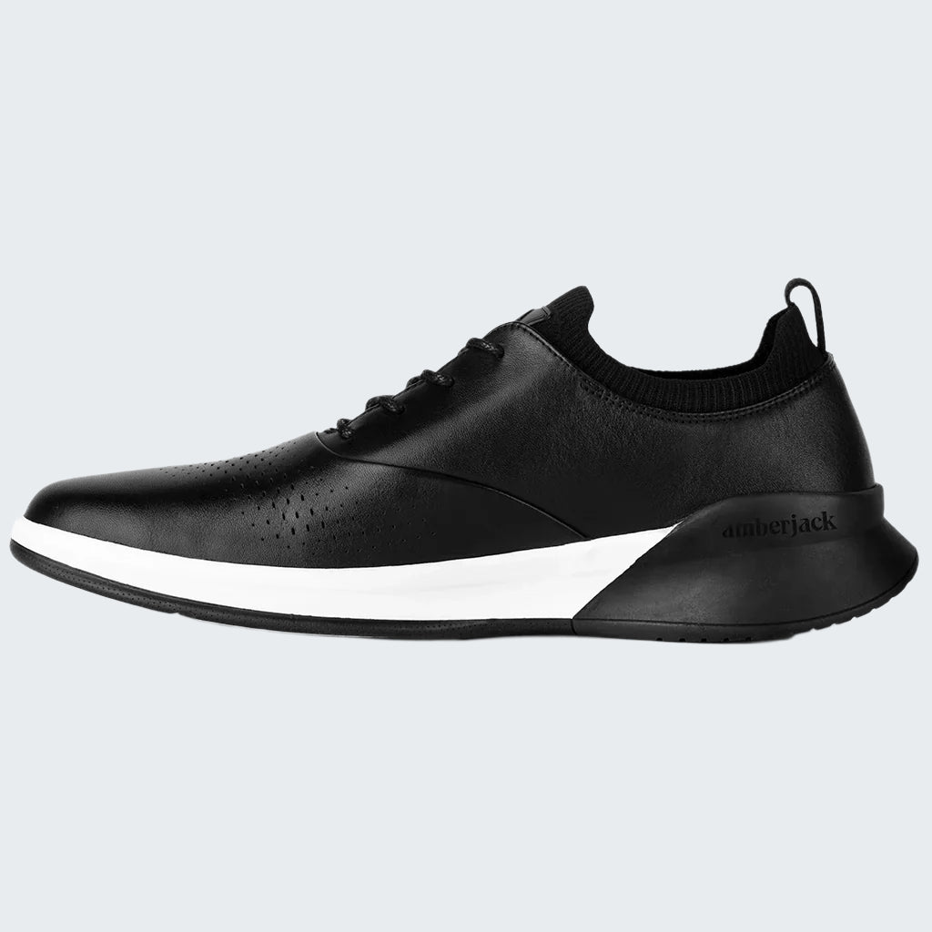 Black sneaker with white sole on a white background