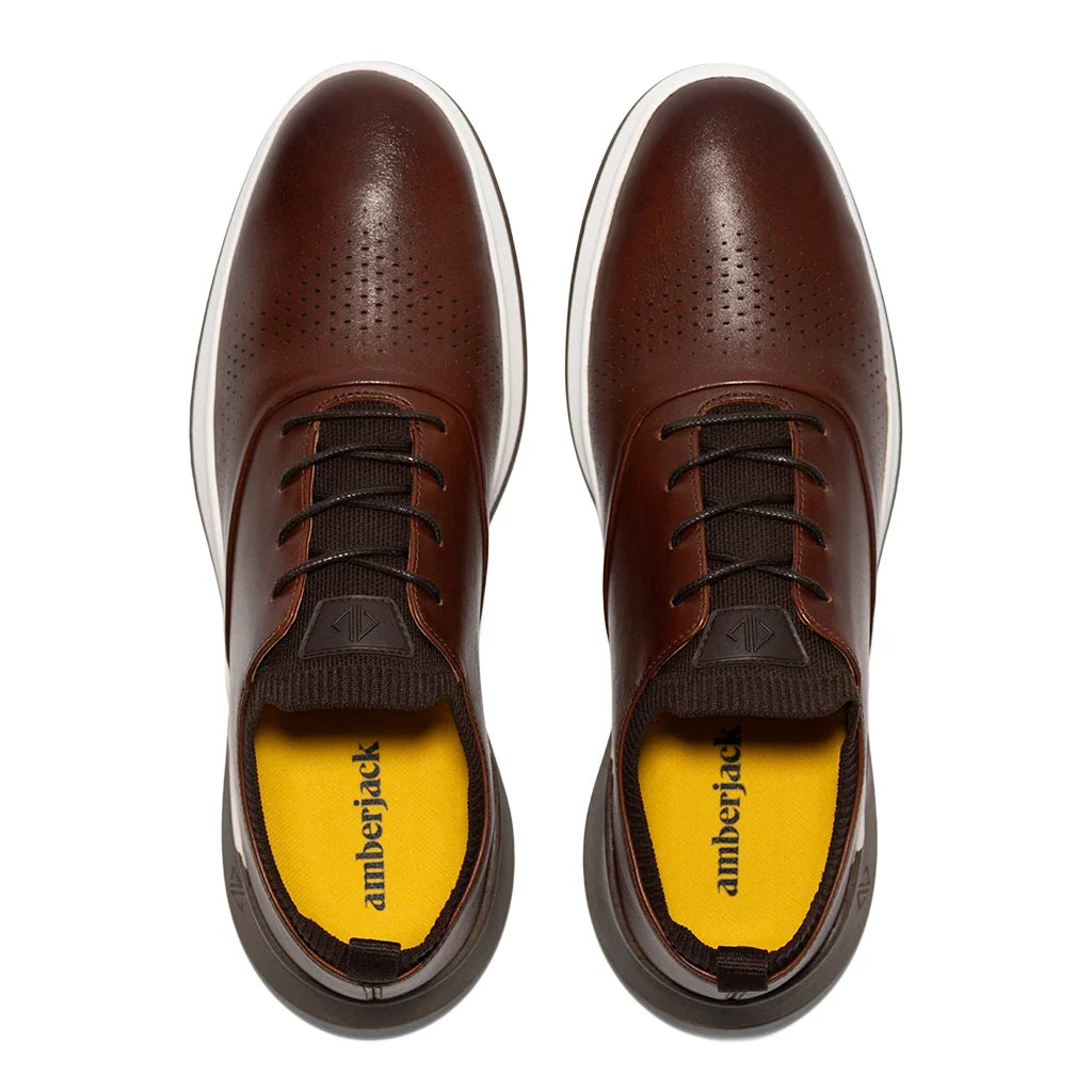 Brown leather shoes with yellow lining on a white background