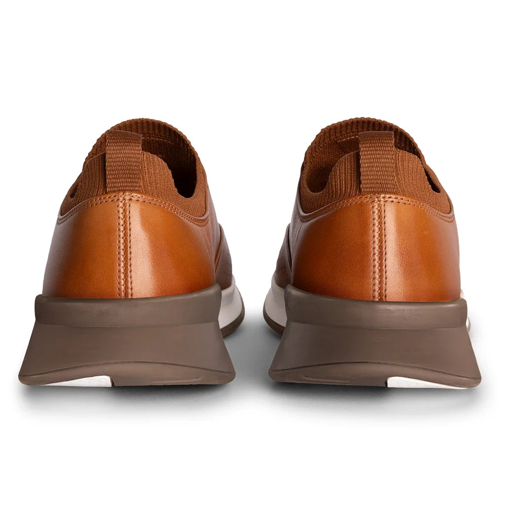 Brown leather shoes with a white sole on a white background