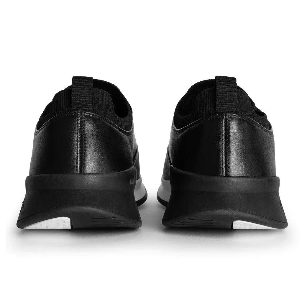 Black slip-on shoes on a white background