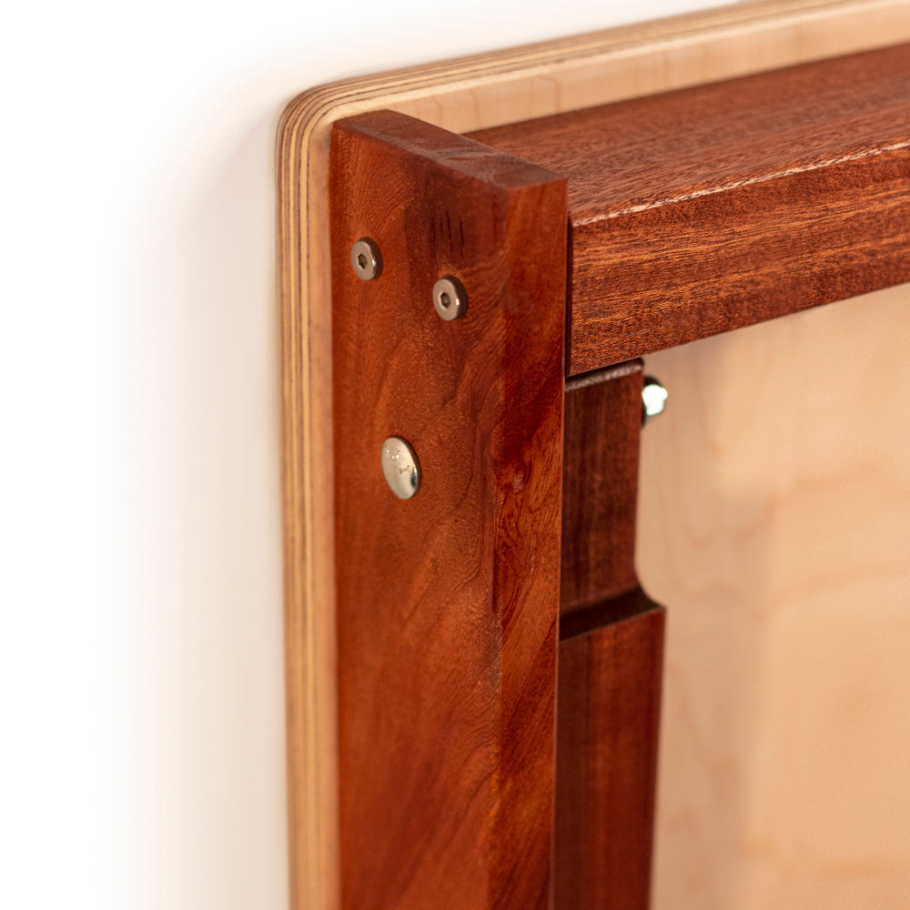 Close-up of a wooden frame with metal fasteners on a white background