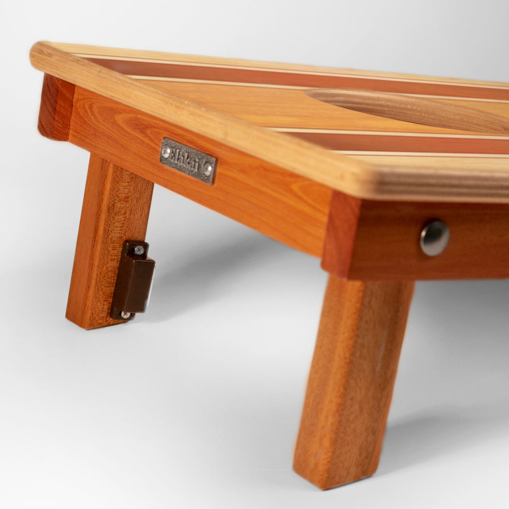 Wooden footstool with a visible brand label on a white background
