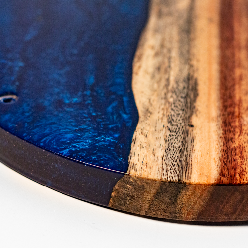 Close-up of a wooden surface with blue and brown patterns on a white background