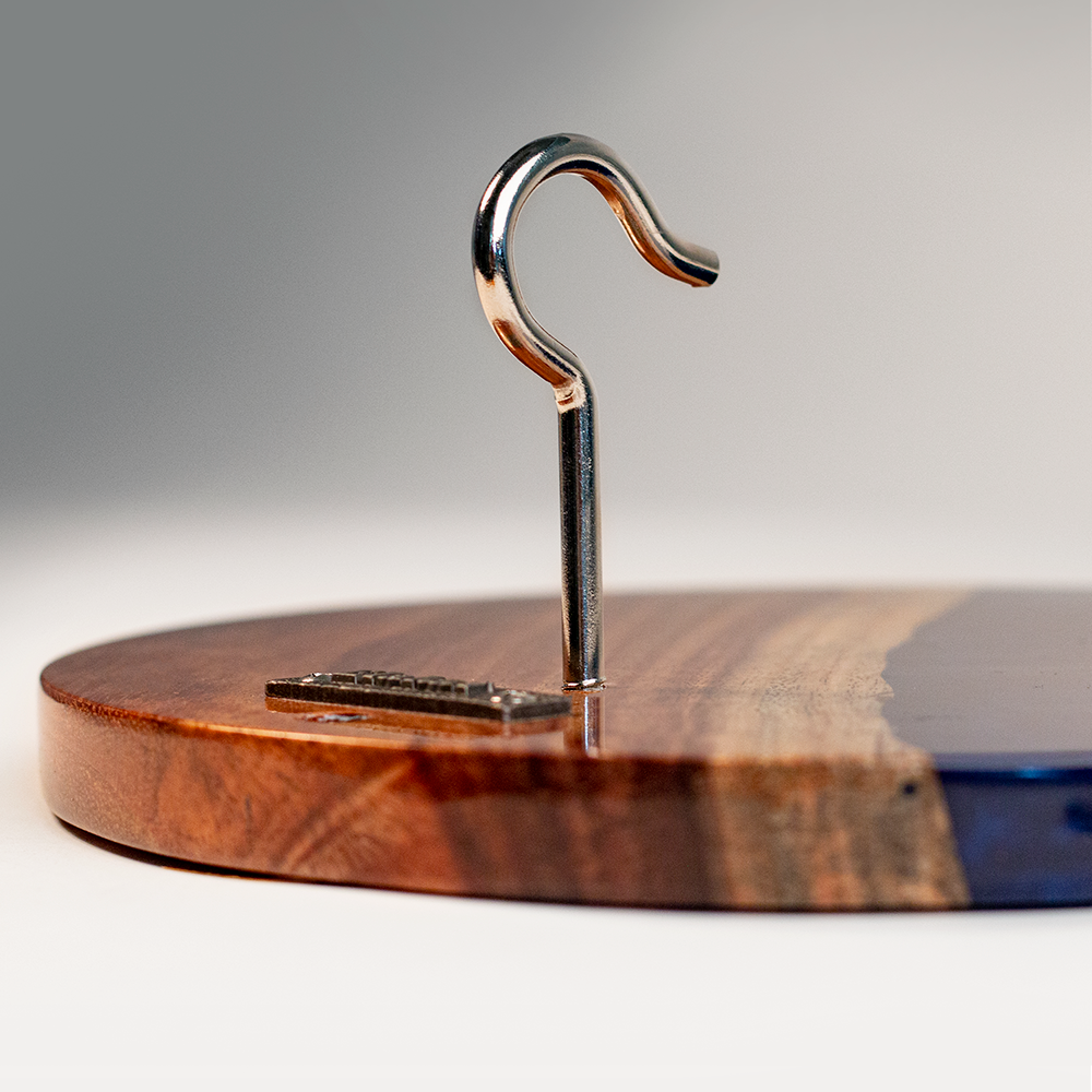 Wooden base with a metal hook on a gray background