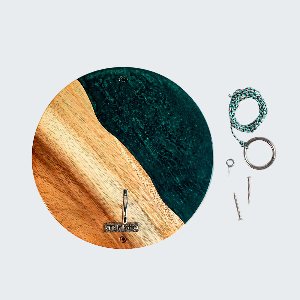 Round wall clock with wooden and teal design, accompanied by keys and a keychain on a white background.
