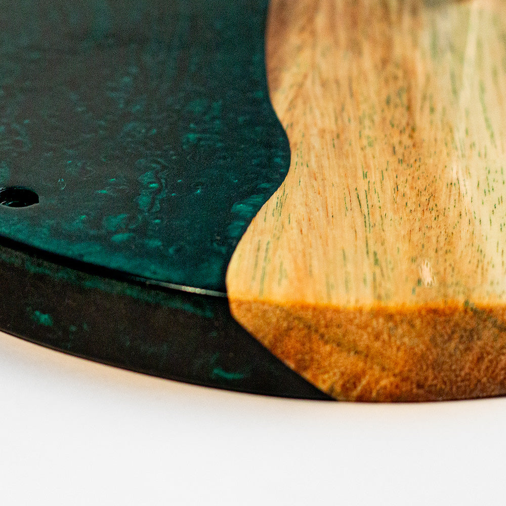 Close-up of a wooden and green resin coaster on a white background