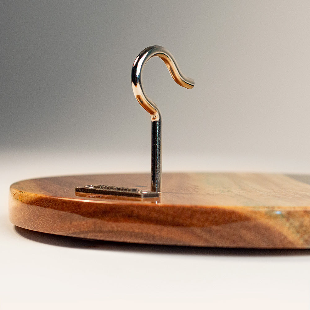 Wooden stand with a metal hook on a gray background