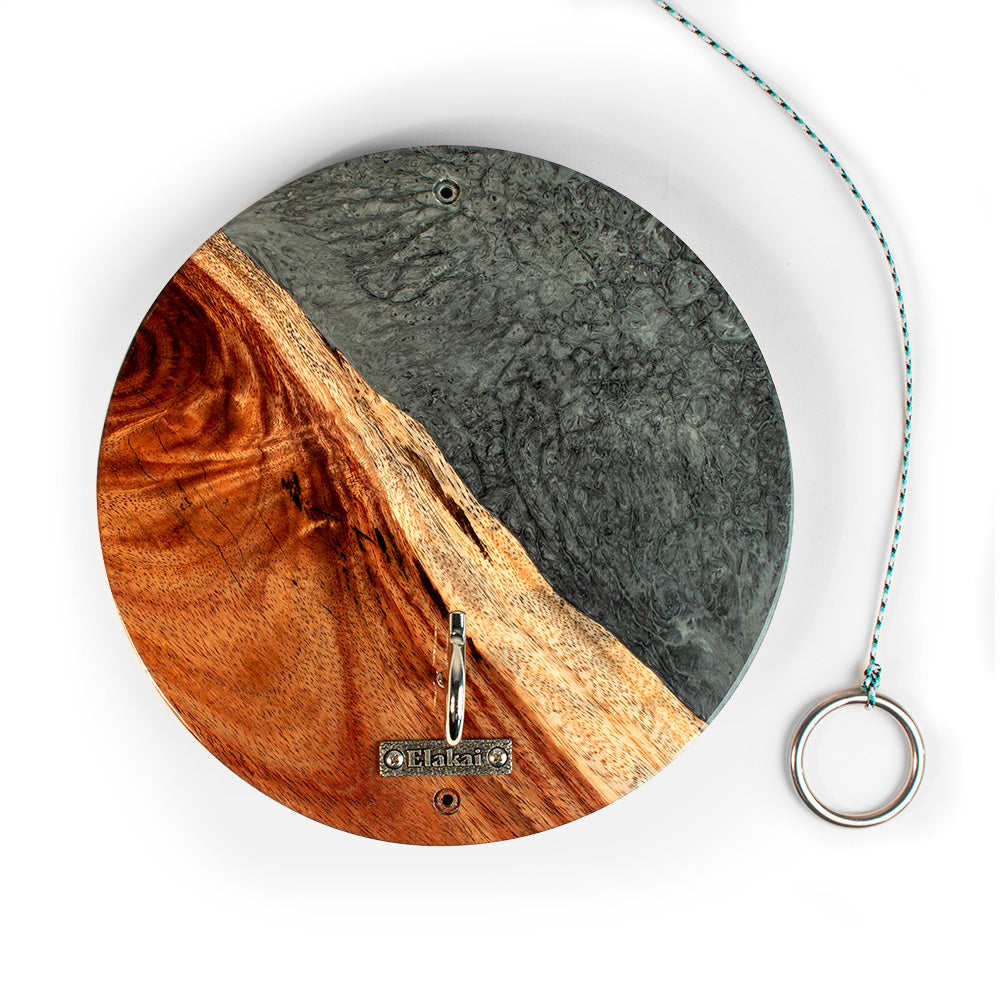 Round wall clock with wooden and metallic design on a white background