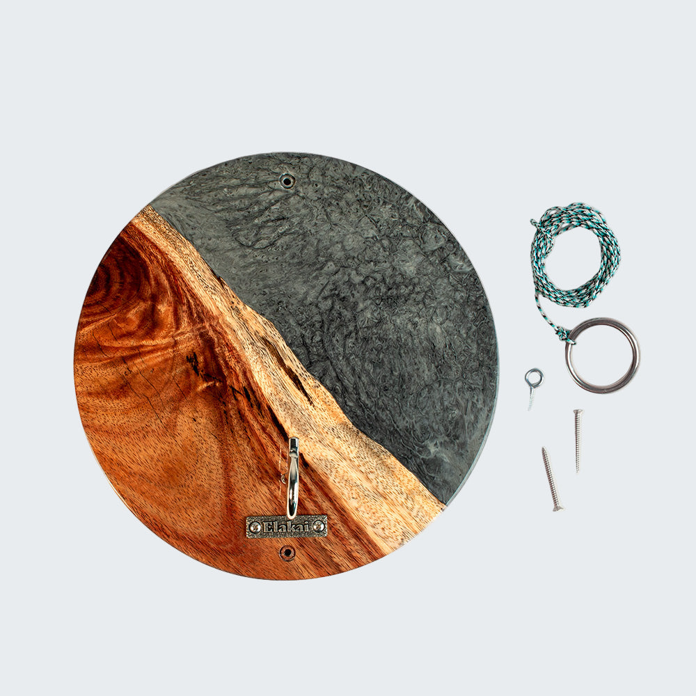 Round wooden and concrete wall hook with keys and a bracelet on a white background