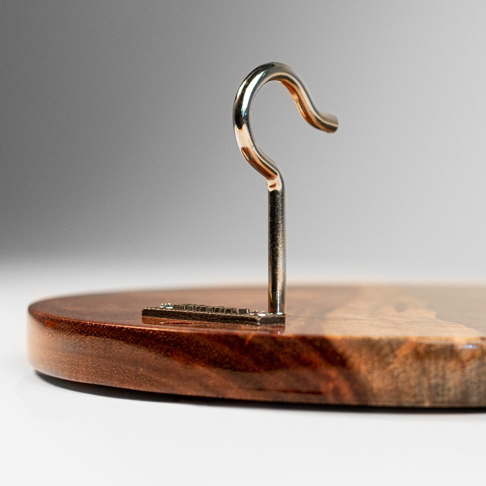 Wooden hanger with a metal hook on a gray background