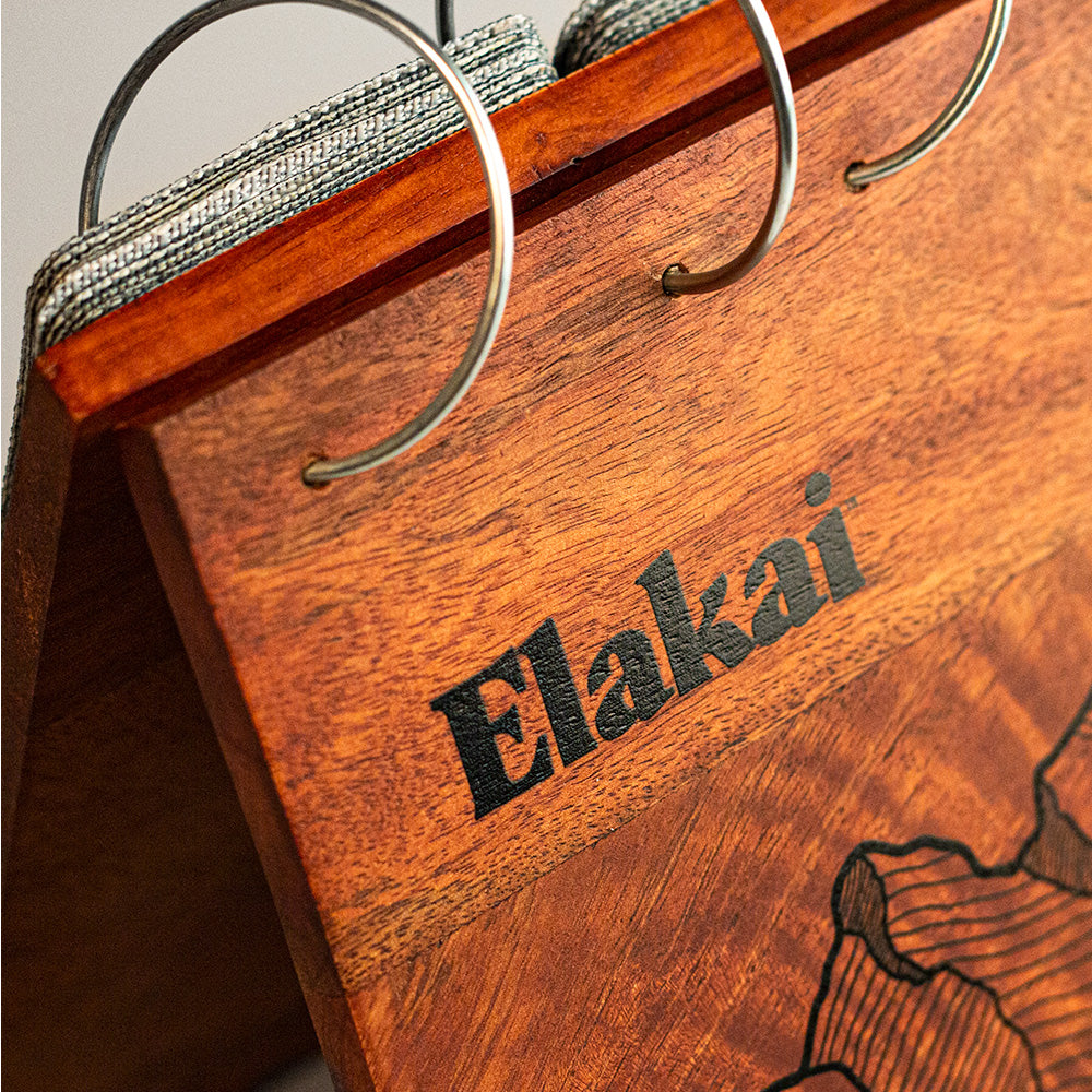 Wooden hanger with 'Elakai' branding on a neutral background