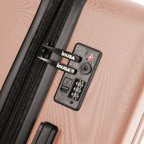 Close-up of a suitcase with an inUSA lock on a beige background