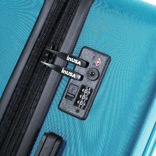 Close-up of a blue suitcase with an inUSA lock on a blue background