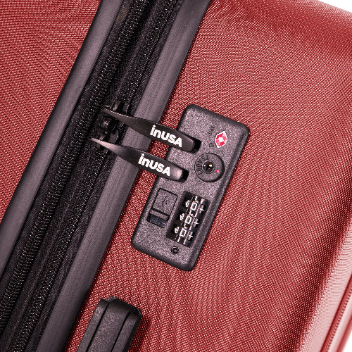 Close-up of a red suitcase with an inUSA lock on a white background