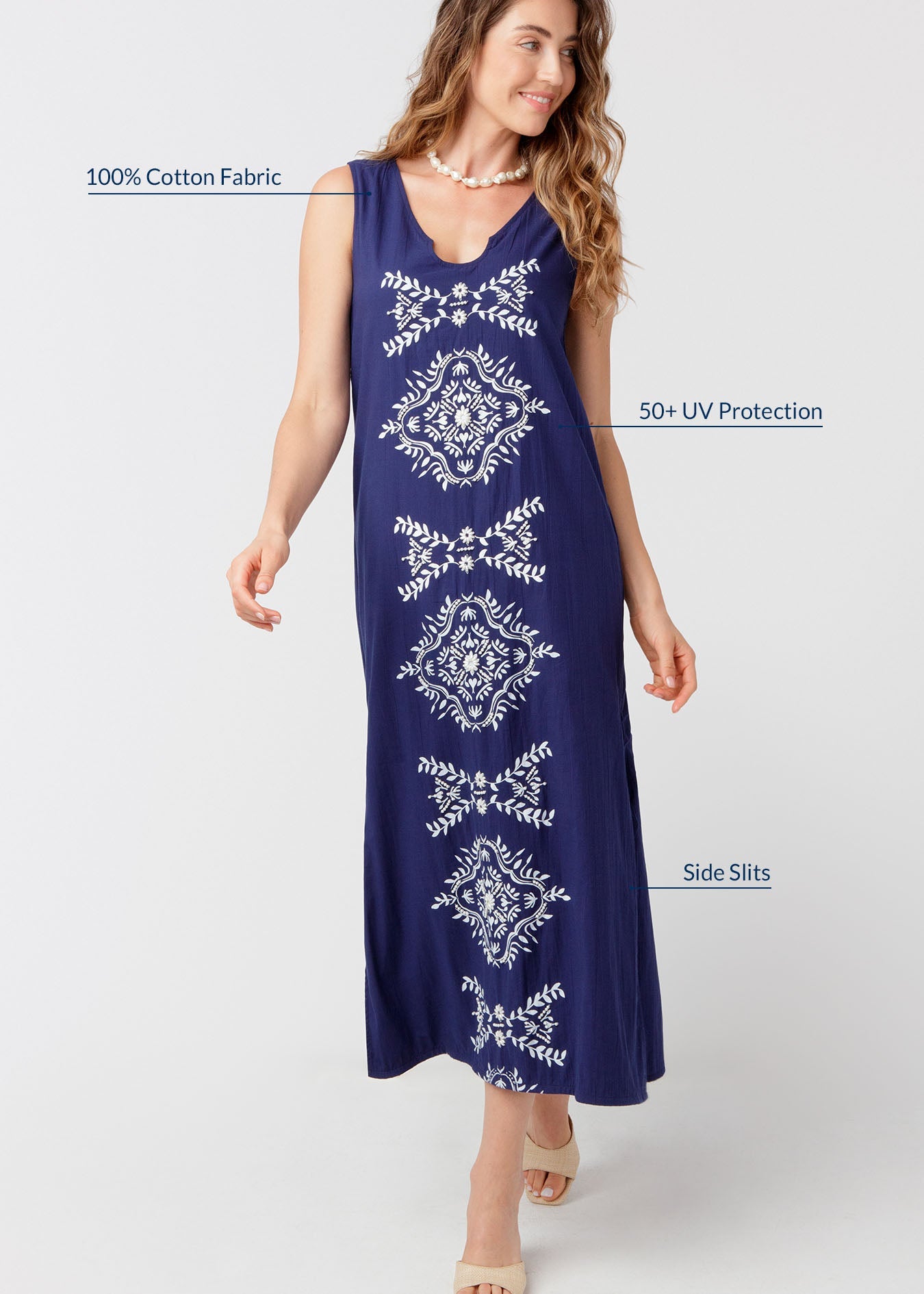 Woman wearing a navy blue dress with white patterns on a white background