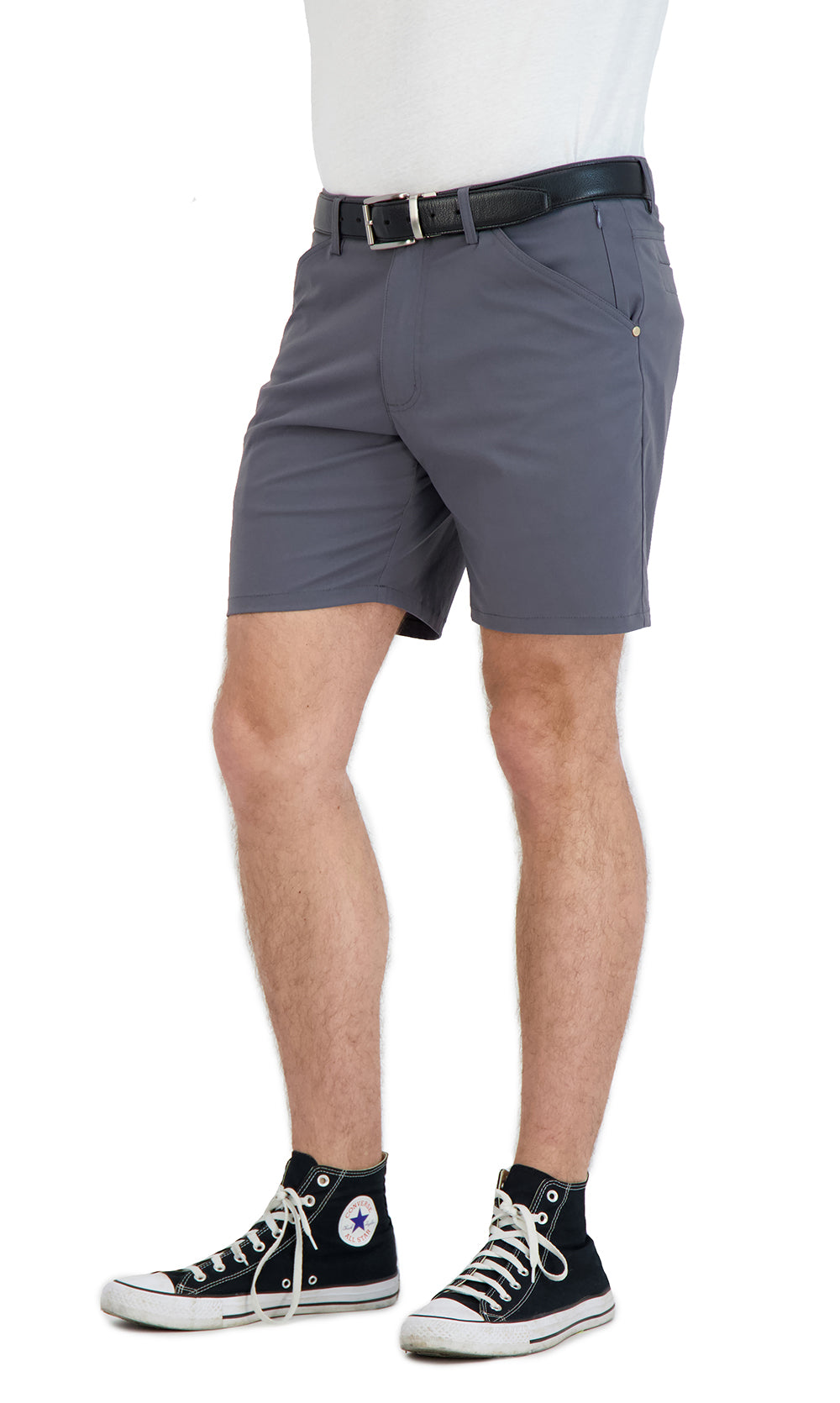 Person wearing gray shorts and black sneakers on a white background