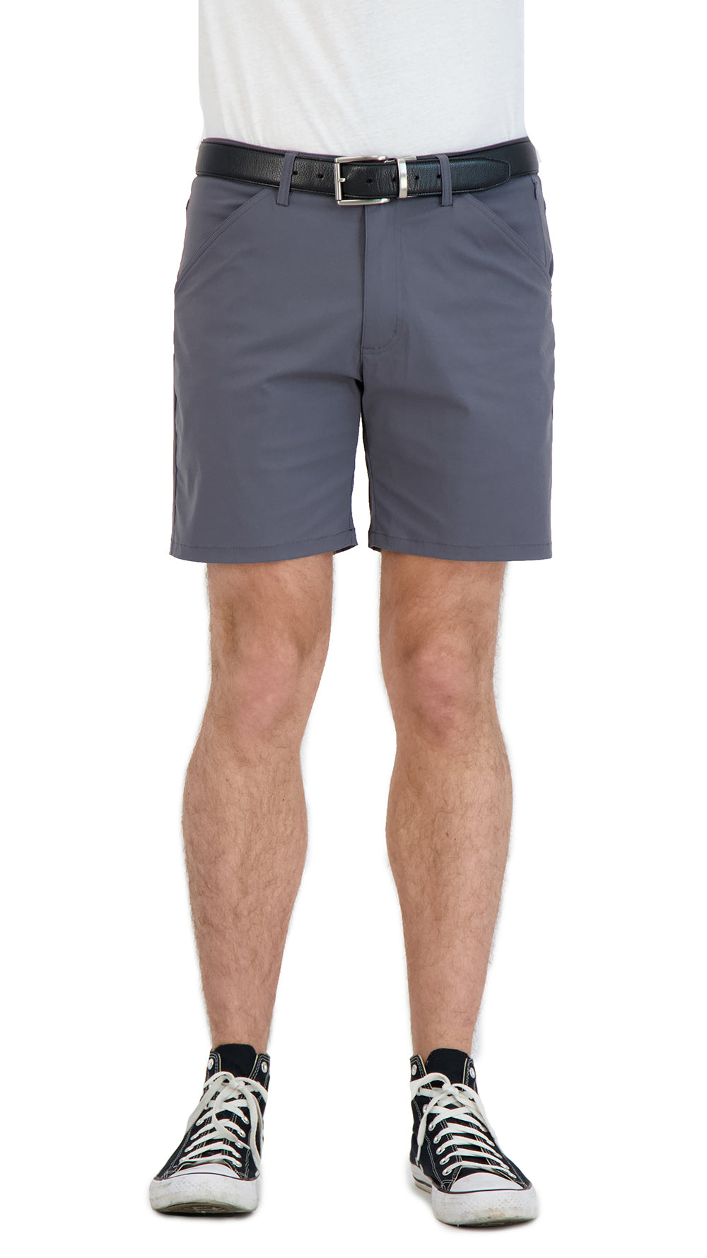 Person wearing gray shorts with a white shirt and black sneakers on a white background